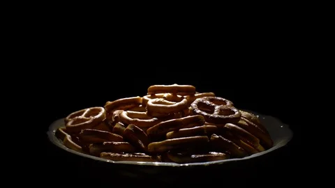 Pretzel salted in rotation. Close up. Studio shot. Black background. Stock Footage 102664488