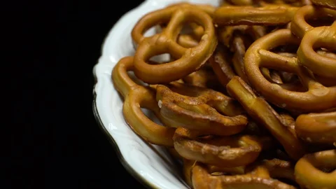 Pretzel salted in rotation. Close up. Studio shot. Black background. Stock Footage 102664810