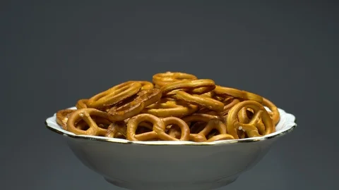 Pretzel salted in rotation. Close up. Studio shot. Grey background. Stock Footage 102665138
