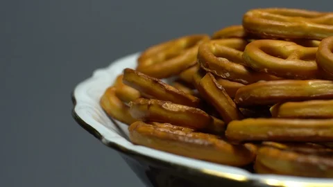 Pretzel salted in rotation. Close up. Studio shot. Grey background. Stock Footage 102668173