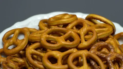 Pretzel salted in rotation. Close up. Studio shot. Grey background. Stock Footage 102668231