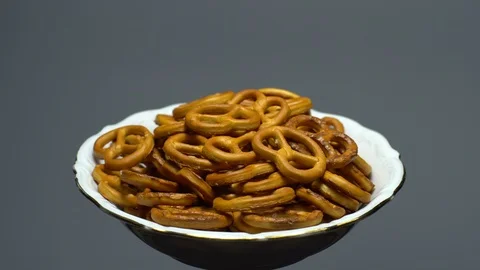 Pretzel salted in rotation. Close up. Studio shot. Grey background. Stock Footage 102668691