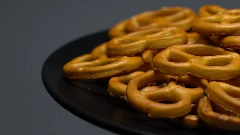 Pretzel salted in rotation. Close up. Studio shot. Grey background. Stock Footage 102668882