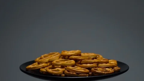 Pretzel salted in rotation. Close up. Studio shot. Grey background. Stock Footage 102677773
