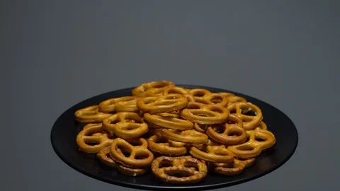 Pretzel salted in rotation. Close up. Studio shot. Grey background. Stock Footage 102677896