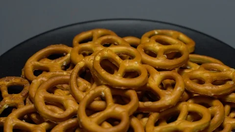 Pretzel salted in rotation. Close up. Studio shot. Grey background. Stock Footage 102678282