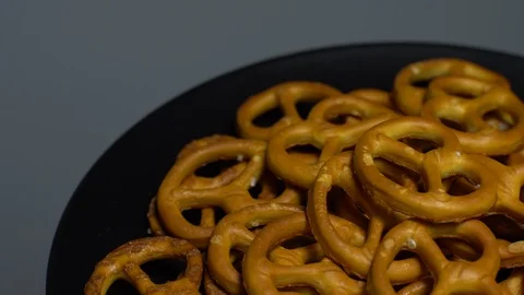 Pretzel salted in rotation. Close up. Studio shot. Grey background. Stock Footage 102678520
