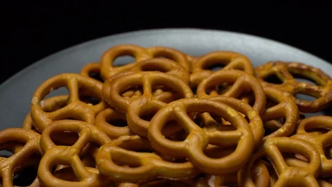 Pretzel salted in rotation. Close up. Studio shot. Black background. Stock Footage 102678867