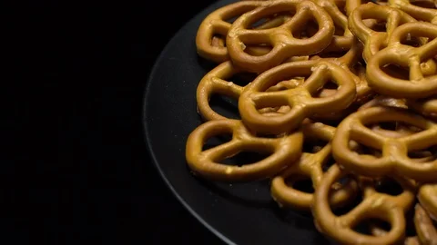 Pretzel salted in rotation. Close up. Studio shot. Black background. Stock Footage 102678870