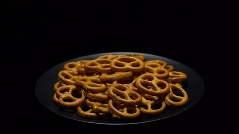 Pretzel salted in rotation. Close up. Studio shot. Black background. Stock Footage 102678890