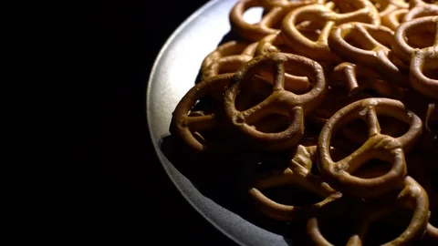 Pretzel salted in rotation. Close up. Studio shot. Black background. Stock Footage 102679189