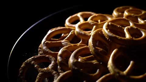 Pretzel salted in rotation. Close up. Studio shot. Black background. Stock Footage 102679202