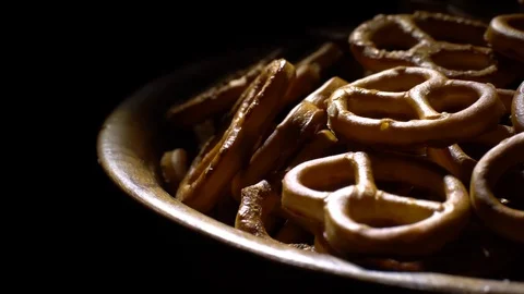 Pretzel salted in rotation. Close up. Studio shot. Black background. Stock Footage 102679211