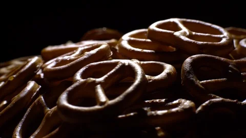 Pretzel salted in rotation. Close up. Studio shot. Black background. Stock Footage 102679567