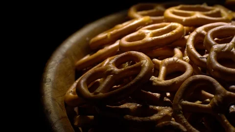 Pretzel salted in rotation. Close up. Studio shot. Black background. Stock Footage 102679586