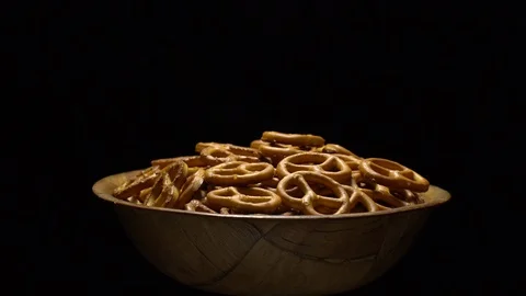 Pretzel salted in rotation. Close up. Studio shot. Black background. Stock Footage 102679694