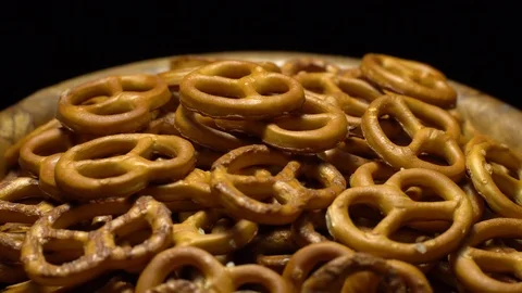 Pretzel salted in rotation. Close up. Studio shot. Black background. Stock Footage 102679828