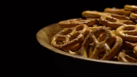 Pretzel salted in rotation. Close up. Studio shot. Black background. Stock Footage 102679831