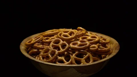 Pretzel salted in rotation. Close up. Studio shot. Black background. Stock Footage 102680015