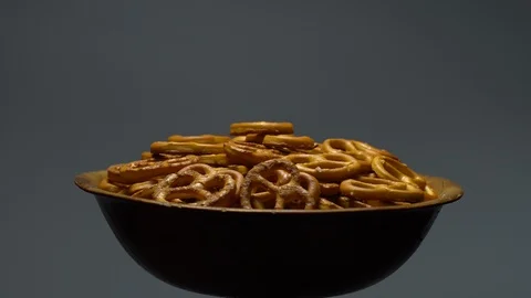 Pretzel salted in rotation. Close up. Studio shot. Grey background. Stock Footage 102680159