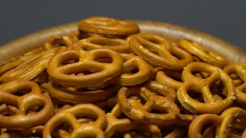 Pretzel salted in rotation. Close up. Studio shot. Grey background. Stock Footage 102680554