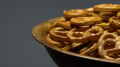 Pretzel salted in rotation. Close up. Studio shot. Grey background. Stock Footage 102680561