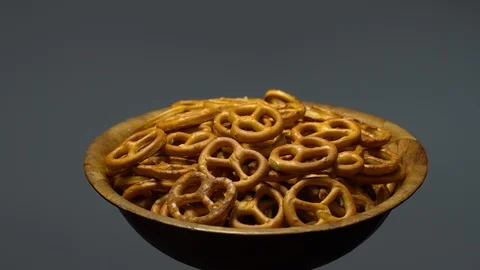 Pretzel salted in rotation. Close up. Studio shot. Grey background. Stock Footage 102680824