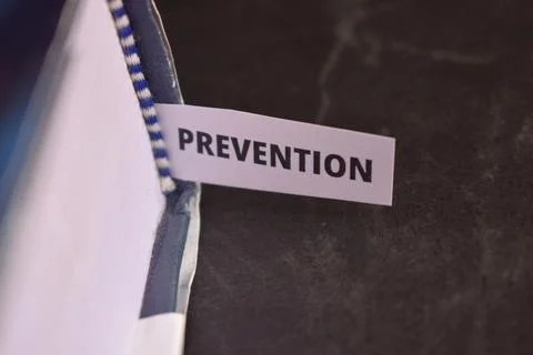 Prevention Paper Tab Between Book Pages Symbolizing Health, Security and Pr.. Fotos Stock