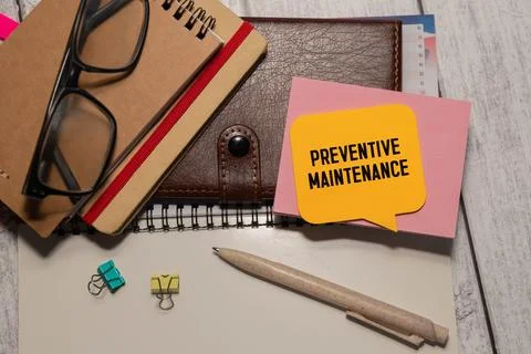 Preventive Maintenance text written on paper with magnifying glass. Stock Photos