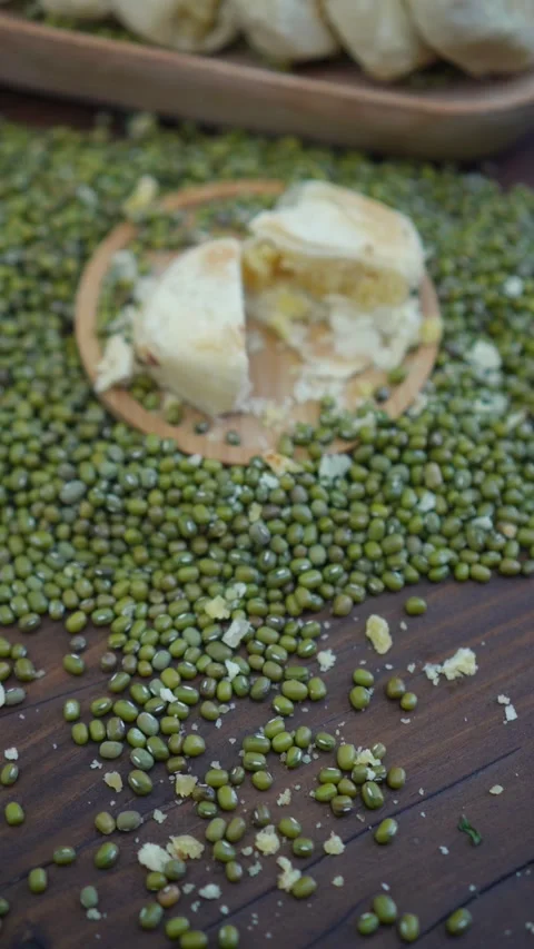 Preview of mung bean cake named bakpia among mung beans on the wood table Stock Footage 283543028