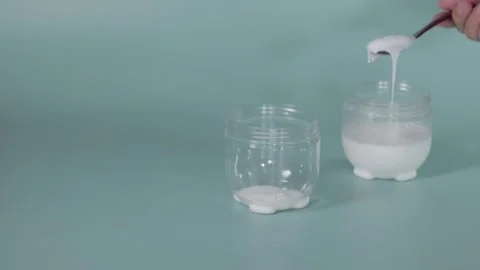 Previously made yogurt added to a fermentation container 動画素材 345881633