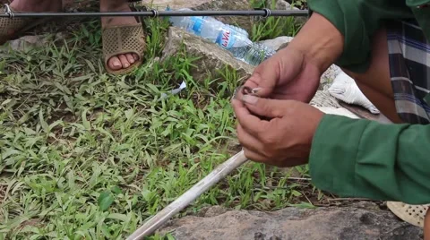 Prey fish hooks, the man sitting by the river fishing Stock Footage 58200716