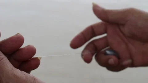 Prey fish hooks, the man sitting by the river fishing Stock Footage 58200859