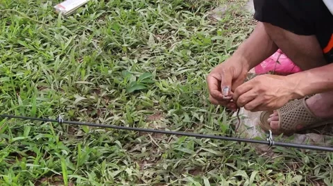 Prey fish hooks, the man sitting by the river fishing Stock Footage 58201171