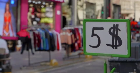 Price of five dollars close-up against background of street with discounted Stock Footage 230935514