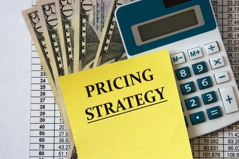 PRICING STRATEGY - words on a white sheet of paper on the background of a cal Stock Photos