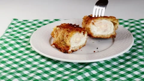 Prick a cordon bleu escalope with a fork. Golden, crispy chicken cordon bleu Stock Footage 283727042