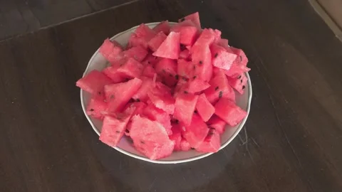 Pricking watermelon slices with fork Stockbeeldmateriaal 342135226