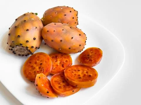 Prickly pear cactus fruit on white plate Stock Photos