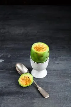 Prickly pear fruit with spoon in egg cup, close view Stock Photos