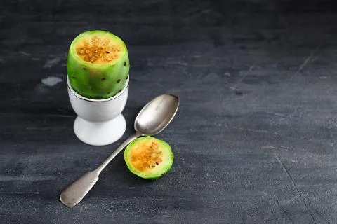 Prickly pear fruit with spoon in egg cup, close view Stock Photos