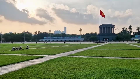 Pride and Serenity: Vietnamese Flag and Pristine Green Lawn in Hanoi Stock Footage 240876121