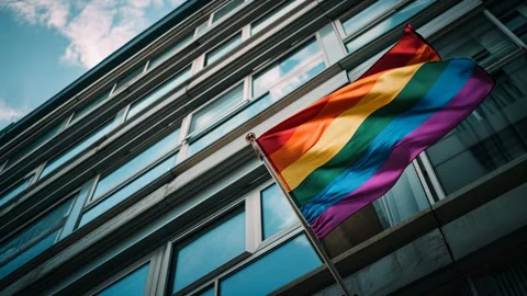 Pride flag moving in the wind on modern building Video stock 317017195