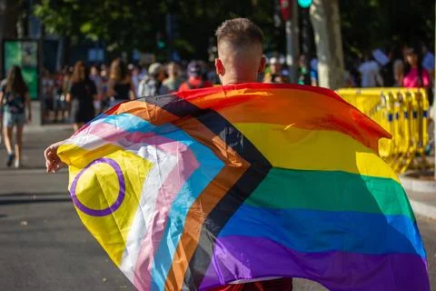 Pride flag walking through the streets during the Madrid Pride parade Stock Photos
