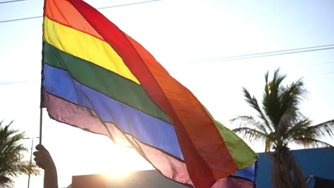 Pride flag waving on a nice sunset lgbt colors supporting his community Stock Footage 247187383