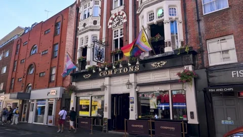 Pride Flags Flying Above Comptons of Soho Pub Frontage Stock Footage 345010491