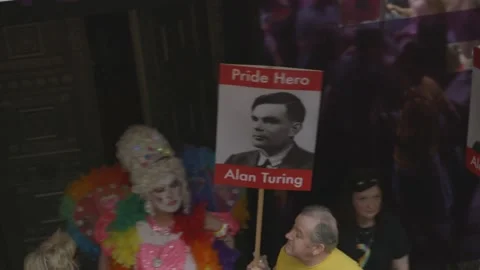 PRIDE HERE ALAN TURING AND STONEWALL PLACARDS AT PRIDE IN LONDON PARADE Stock Footage 130743507