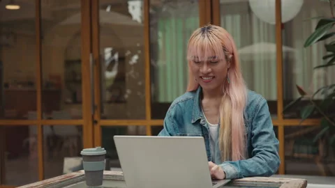 Pride Man in Pink Wig Sitting and Working on Laptop Outside. Stock Footage 311104915