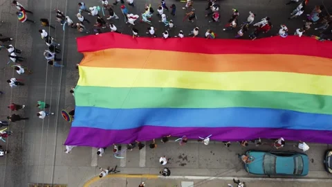 Pride march in 4k passing through the streets of the city proudly carrying Stock Footage 200359662