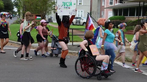 Pride Marchers Wave Flags on a Riverside Street, Jacksonville, Florida Stock Footage 346920004
